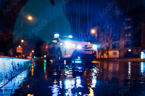 Spain, Madrid, Surface view of police car driving in middle of rainy night photo