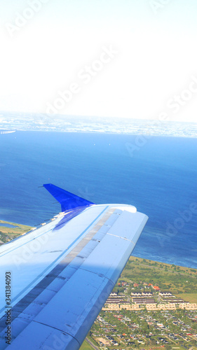 COPENHAGEN, DENMARK - JUL 06th, 2015: Aerial view of Copenhagen airport or Kastrup Danish airport and Copenhagen city from window seat of airplane takeoff over Copenhagen Airport for passenger photo