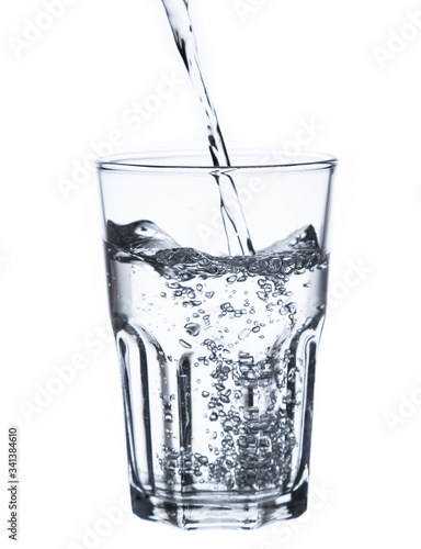pouring water on a glass on white background clipping path