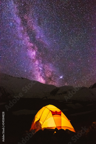 Pamir Lenin Peak Kyrgyzstan Yellow tent on a background of lilac starry sky