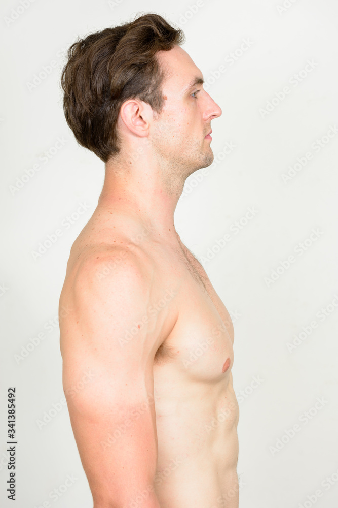 Profile view of young handsome muscular man shirtless