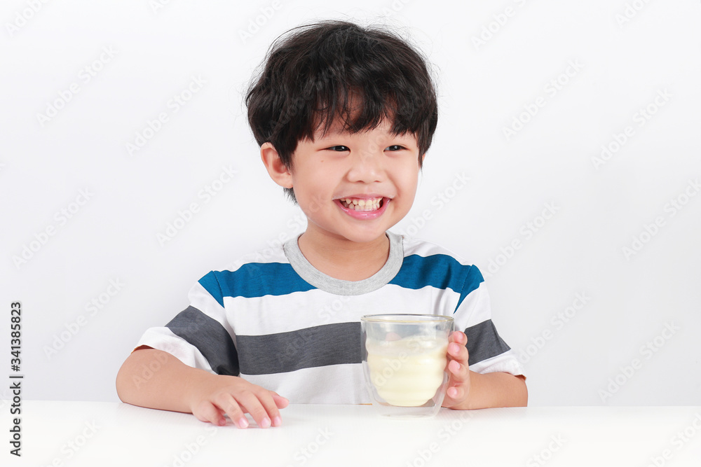 Portrait Of Smiling Boy Holding Milk Against White Background Portrait Of Smiling Boy Holding Milk Against White Background