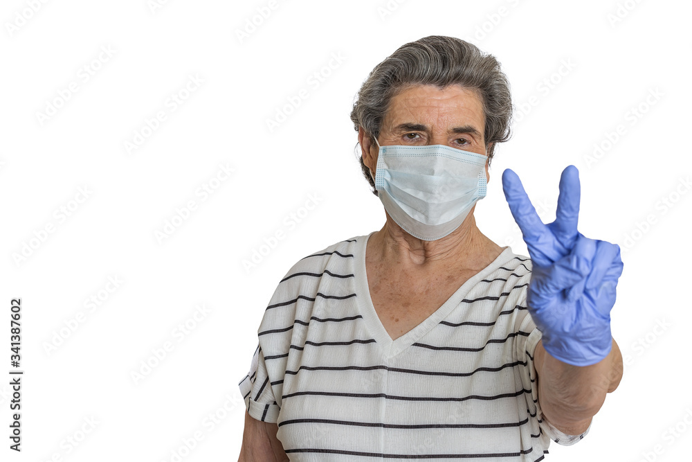 Elderly woman in medical mask gesturing V sign Elderly woman in medical mask gesturing V sign
