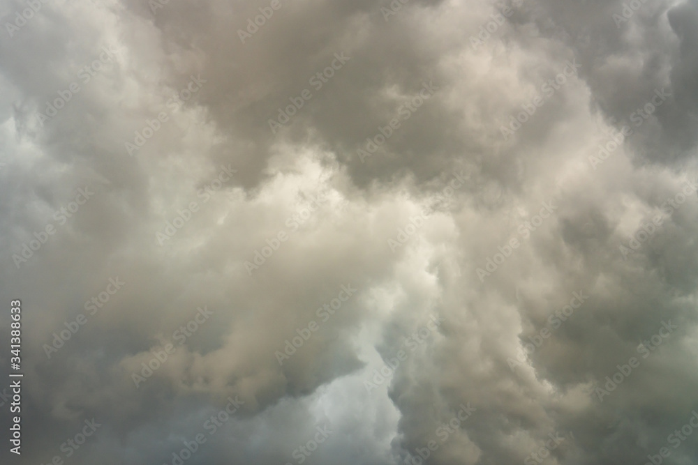 Background of beautiful dark clouds before a raining and thunder-storm. A dramatic sky with gray dense clouds. view from ground surface.sad feel. Background of beautiful dark clouds before a raining and thunder-storm. A dramatic sky with gray dense clouds. view from ground surface.sad feel.
