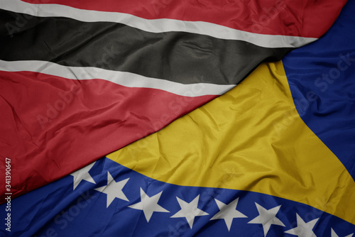 waving colorful flag of bosnia and herzegovina and national flag of trinidad and tobago.