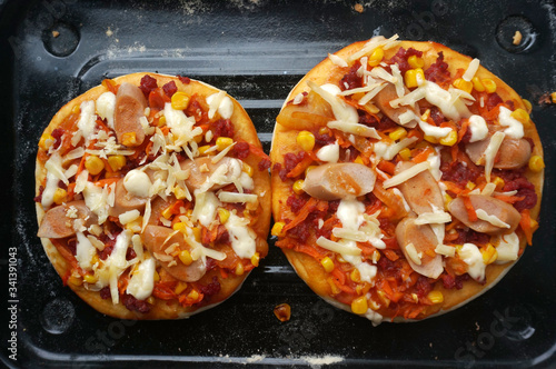 Mini Pizza with sausage, corn, carrot, cheese and Beef. Homemade mini pizza. 