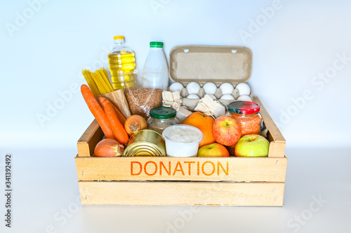 Donation volunteer box with various products for poor people. Pandemic coronavirus food shortages. Food donations or delivery concept white background isolated. Free space for text copyspace mockup