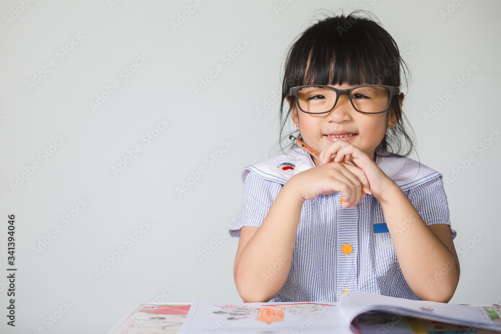 Little asian kid at home doing homework. Little asian kid at home doing homework.