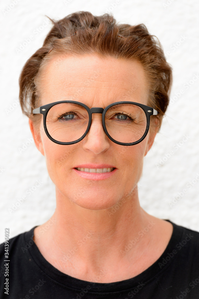 Fototapeta premium Face of beautiful mature woman wearing big eyeglasses and standing against white background outdoors