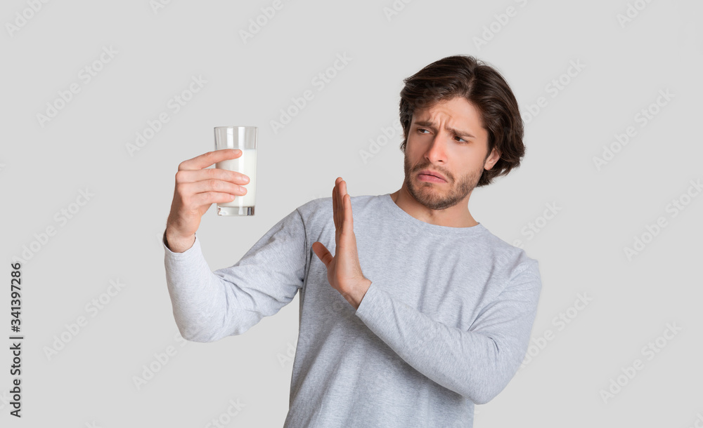 Allergy on lactose concept. Man refuses milk Allergy on lactose concept. Man refuses milk