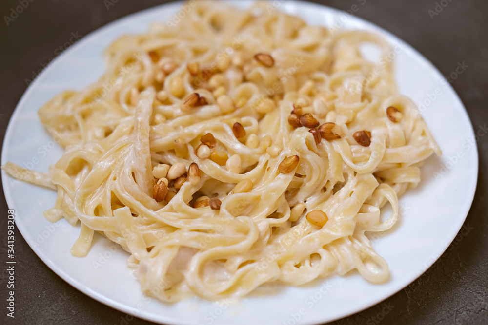 italian pasta with cedar nuts, chicken and bechamel sauce. delicious and tasty local food. traditional pasta recipe. italian pasta with cedar nuts, chicken and bechamel sauce. delicious and tasty local food. traditional pasta recipe.