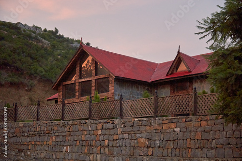Red old wooden hut in the mountains