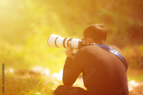 Εκτύπωση καμβά The photographer is shooting with a large long lens