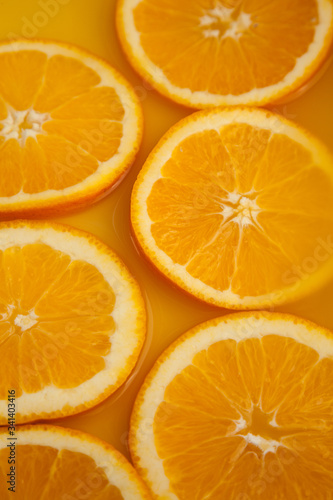 Round fresh orange slices  summer yellow background.