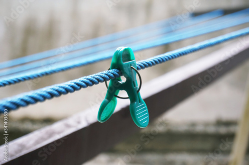 Green clothespin on the hangers. Plastic clothespins