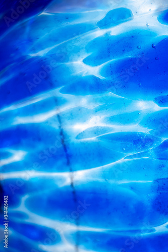 Dark background with blur blue light circles with waves. Abstract defocused pattern