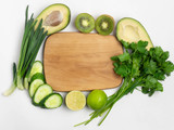 Various vegetables and fruits around the cutting Board on a white background, top view. The concept of healthy eating, food background. Vegan, vegetarian.