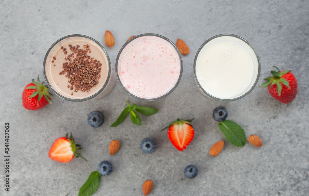Assorted protein cocktails with fresh fruits, berries and chocolate. Protein shake. Sports nutrition and healthy lifestyle concept. Top view. Assorted protein cocktails with fresh fruits, berries and chocolate. Protein shake. Sports nutrition and healthy lifestyle concept. Top view.