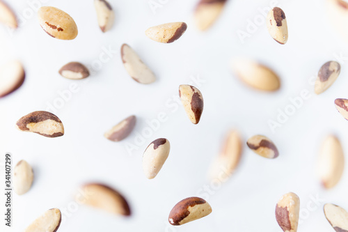 Shelled Brazil nuts flying above white background, levitation effect