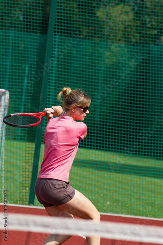 Female tennis player hitting a two-handed backhand return of serve © ffolas