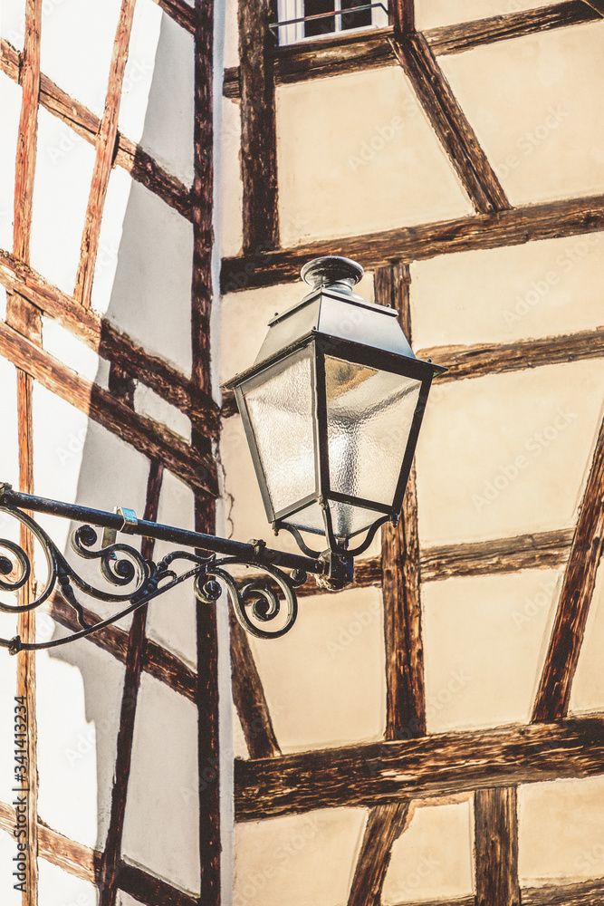 Fotografie Street lantern on the half timbered wall background