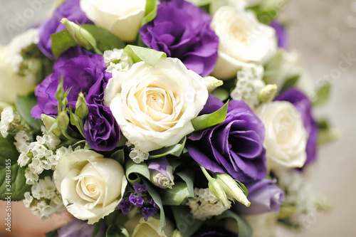 Beautiful wedding bouquet. Set of white and purple roses with lace decor. Selective focus. close up