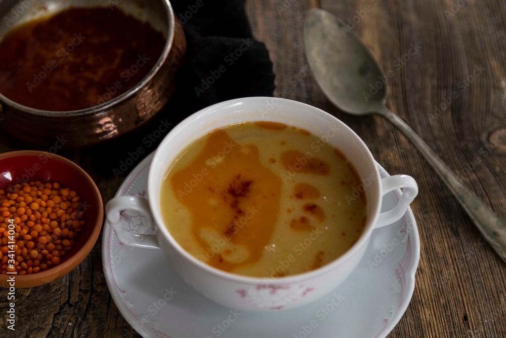 Red Lentil Soup with ingredients on wooden background, top view, copy space. Traditional turkish or arabic lentil and vegetable spicy soup, healthy vegan food. Red Lentil Soup with ingredients on wooden background, top view, copy space. Traditional turkish or arabic lentil and vegetable spicy soup, healthy vegan food.