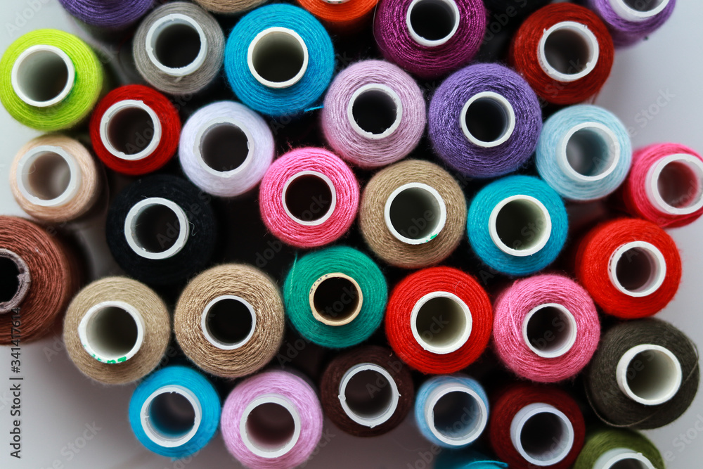 balls of sewing thread of different colors on a white background balls of sewing thread of different colors on a white background