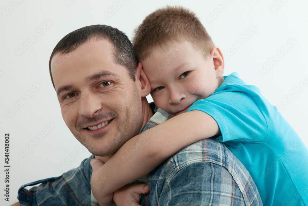 Happy father and son playing and laughing together at home. Happy father and son playing and laughing together at home.