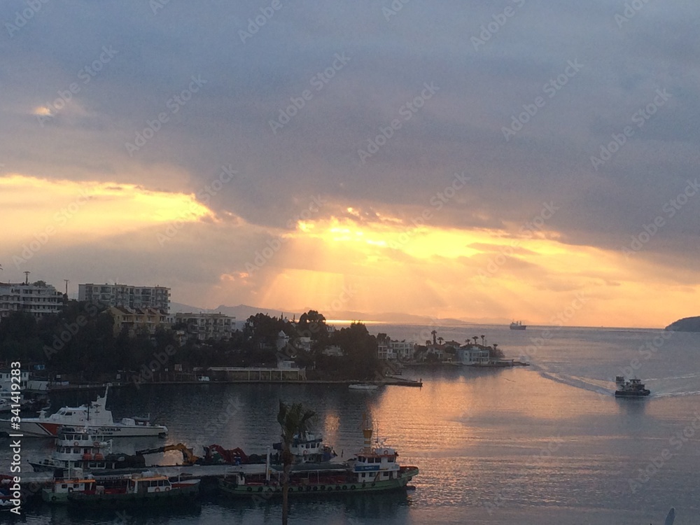 Gulluk, Mugla, TURKEY - 14 September 2017: Amazing golden sunset over the pier. Golden romantic hours.