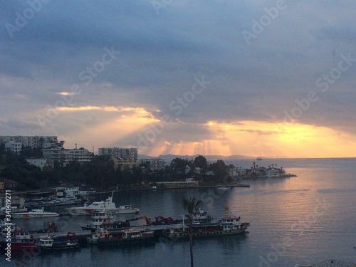 Gulluk, Mugla, TURKEY - 14 September 2017: Amazing golden sunset over the pier. Golden romantic hours. © Светлана Кокорина