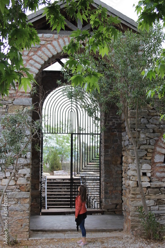 Kiyikislacik, Turkey: 10.10.2017 - Girl is staing in front entrance gate of popular museum and outdoor venues in Kiyikislacik region. photo