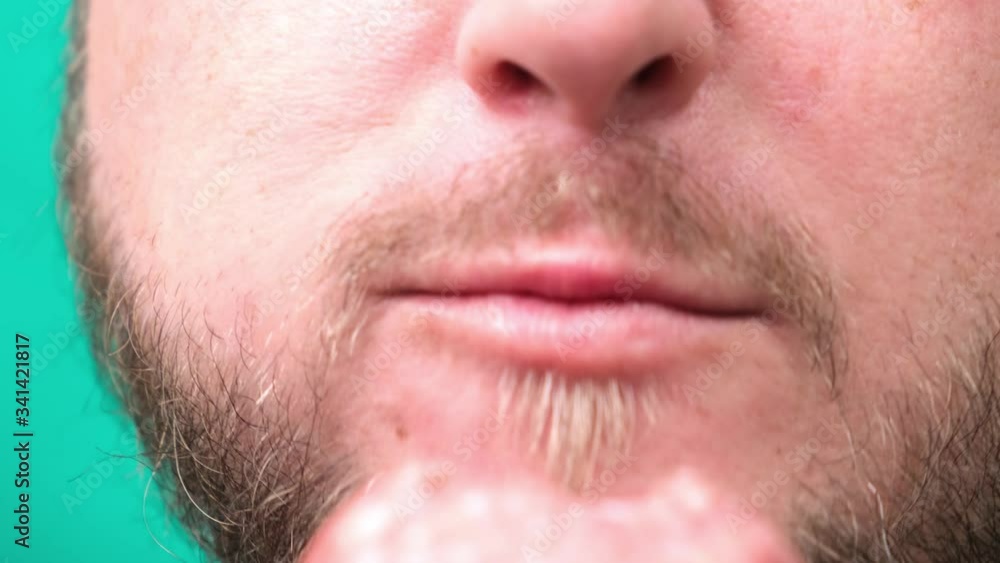 A fat chubby man with a beard eats sausage or meat, a concept of harmful unhealthy lifestyle. A fat chubby man with a beard eats sausage or meat, a concept of harmful unhealthy lifestyle.