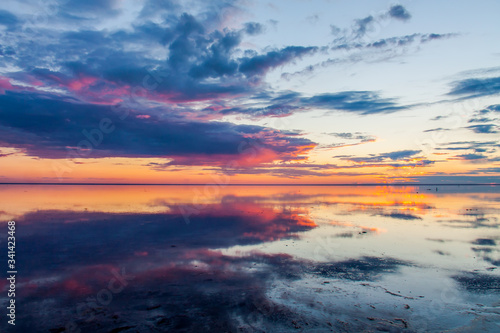 A sunset over a body of water © Игорь Соловьев