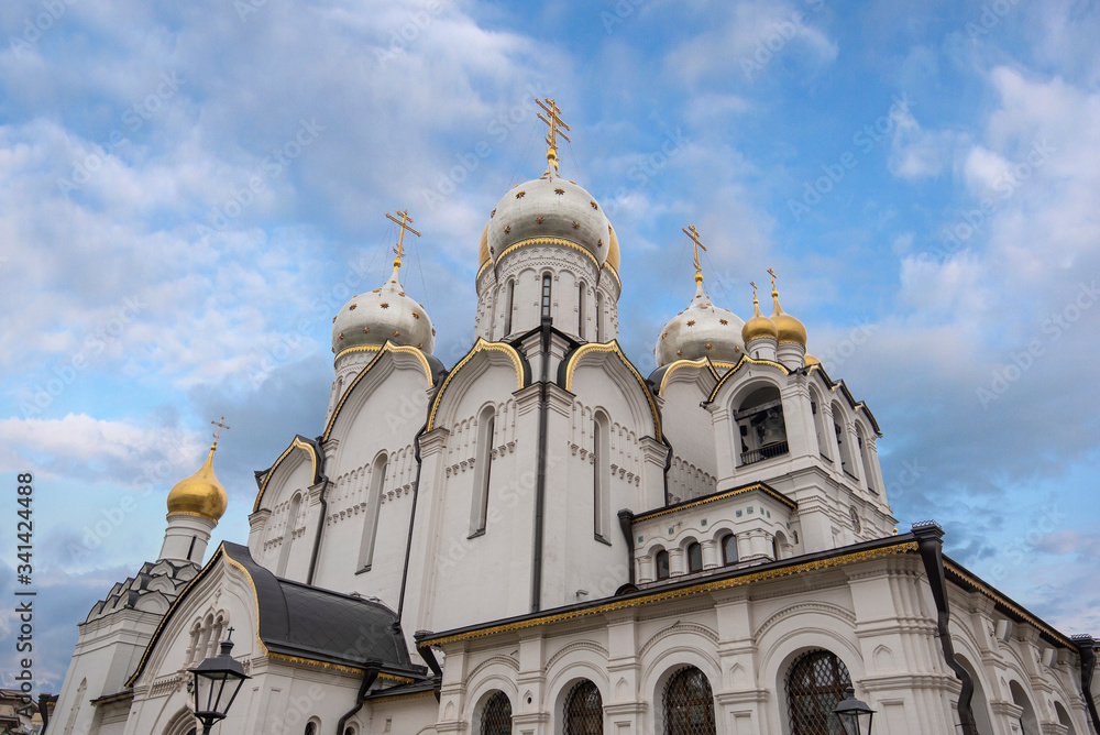 Zachatyevsky Monastery Katholikon in Ostozhenka district, Moscow, Russia. Nativity of Virgin Mary Cathedral. Orthodox church and blue cloudy sky. 