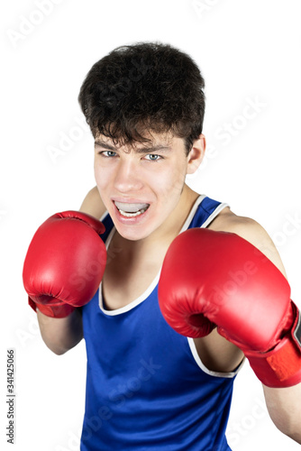 Teenage sportsman in boxing gloves and clothing with special protection on teeth against blows on a white background prepares for battle © Мар'ян Філь