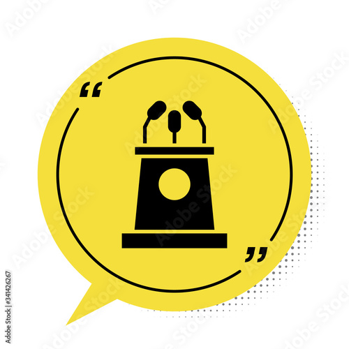 Black Stage stand or debate podium rostrum icon isolated on white background. Conference speech tribune. Yellow speech bubble symbol. Vector Illustration