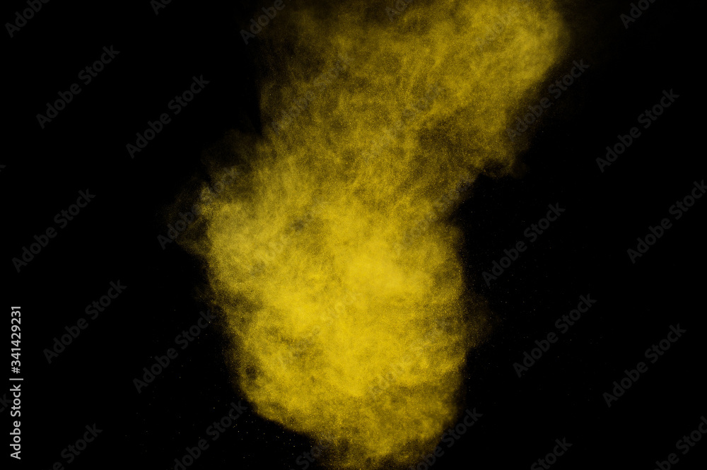 Yellow powder explosion on black background. Colored powder cloud. Colorful dust explode. Paint Holi. Yellow powder explosion on black background. Colored powder cloud. Colorful dust explode. Paint Holi.
