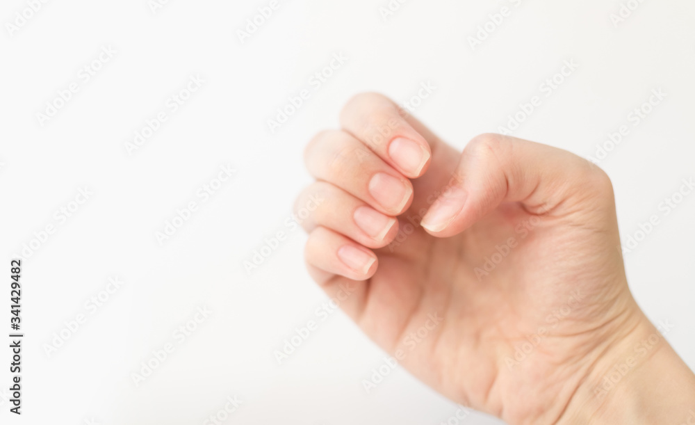 Close up woman hand holds something in fingers. Female keeps virtual object. Nail care at home. Copy space. Close up woman hand holds something in fingers. Female keeps virtual object. Nail care at home. Copy space.