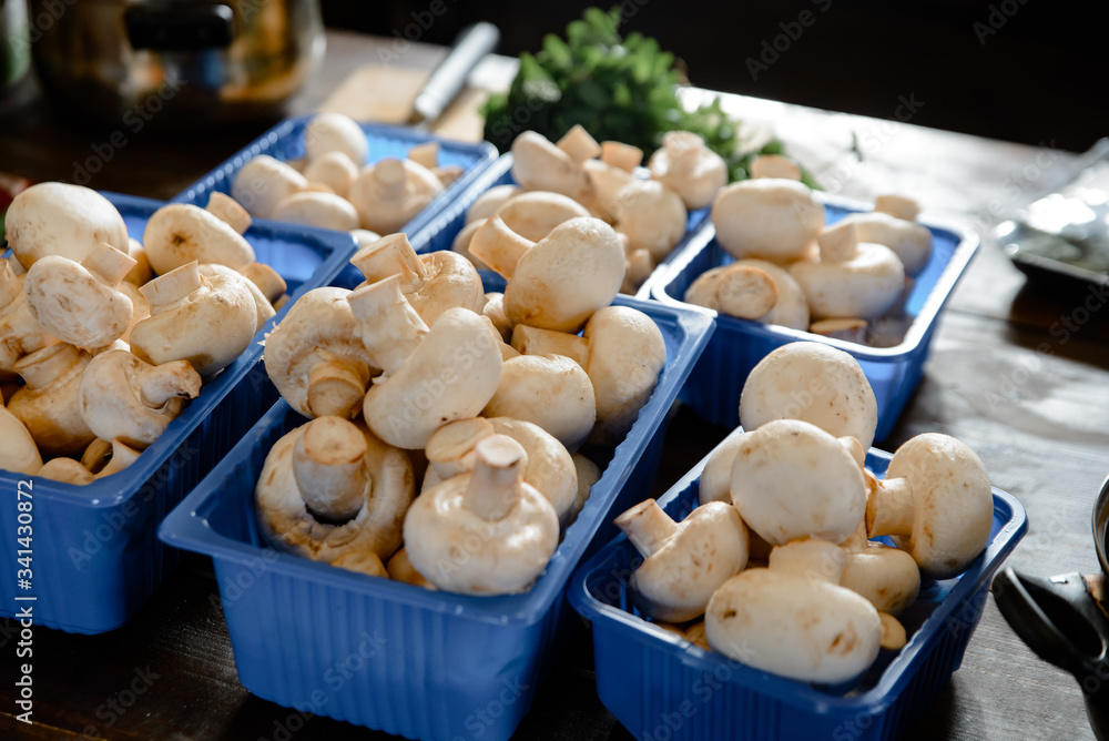 Fresh champignons in plastic packaging isolated on white background. Top side view. Clipping path. Fresh champignons in plastic packaging isolated on white background. Top side view. Clipping path.
