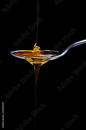 fresh honey pouring over a spoon