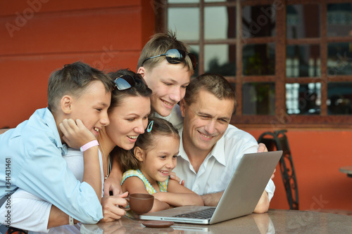 Portrait of a happy family with laptop © aletia2011
