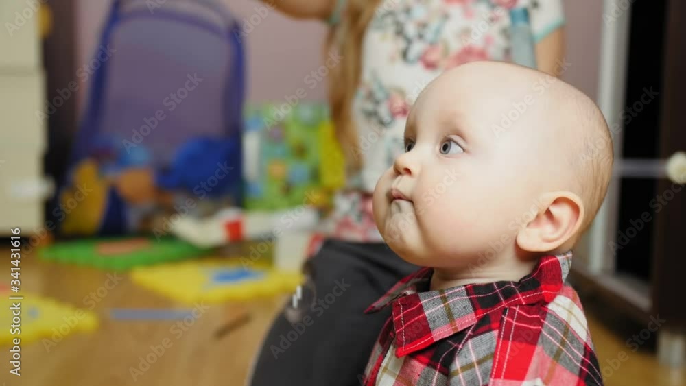 Small girl blowing bubbles for little brother at home. Small girl blowing bubbles for little brother at home.