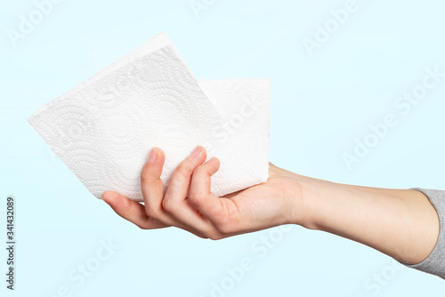A paper napkin or paper towel in a woman 's hand. Concept of hygiene, infection prevention, coronavirus