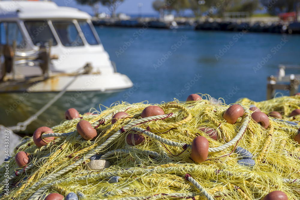 Empty yellow fishing nets and ropes on the dock near white boat. Fisherman, sailor concept. Empty yellow fishing nets and ropes on the dock near white boat. Fisherman, sailor concept.