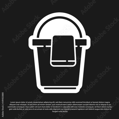 Black Bucket with rag icon isolated on black background. Cleaning service concept.  Vector Illustration
