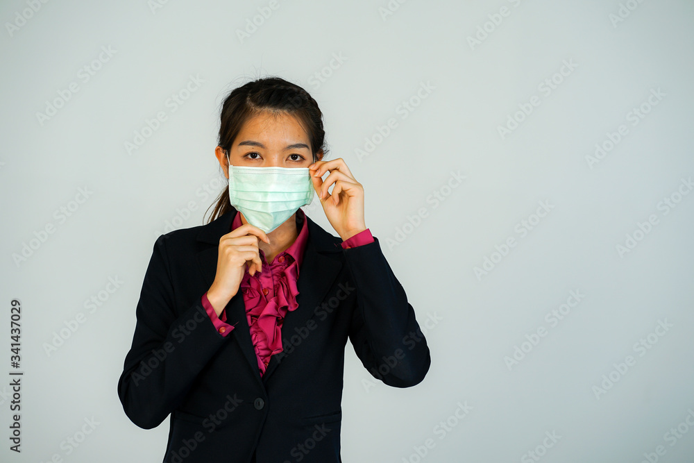 portrait of a businesswoman wearing medical protective face mask to prevent her health and standing at the white background copy space portrait of a businesswoman wearing medical protective face mask to prevent her health and standing at the white background copy space