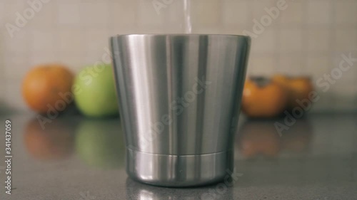 Reusable stainless steel tumbler or cup with water pouring. Waste free, clean living environmental continuous concept	