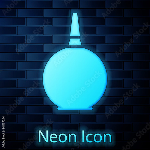 Glowing neon Enema icon isolated on brick wall background. Enema with a plastic tip. Medical pear.  Vector Illustration