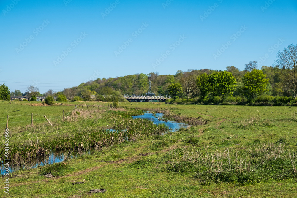 Countryside landscape with distant railway bridge Countryside landscape with distant railway bridge